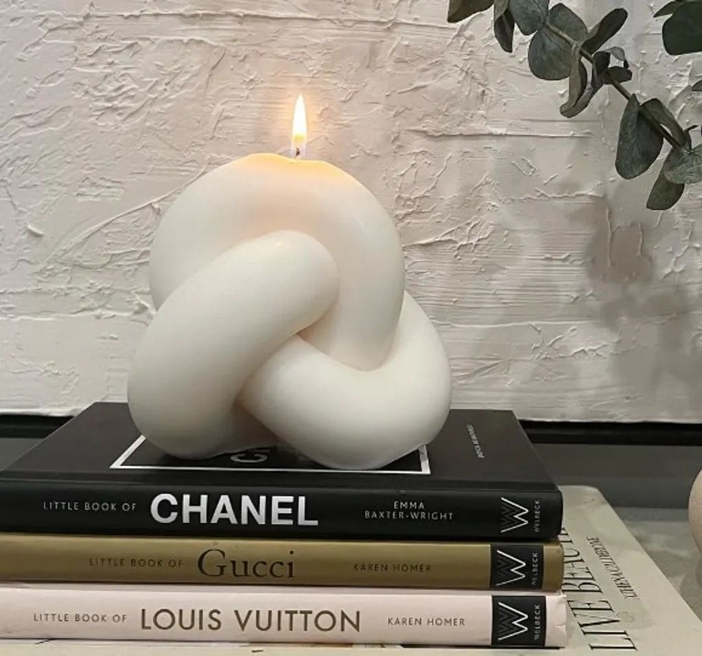 A candle that is on top of some books