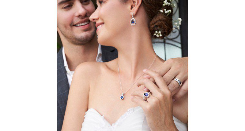 A man and woman wearing wedding jewelry.