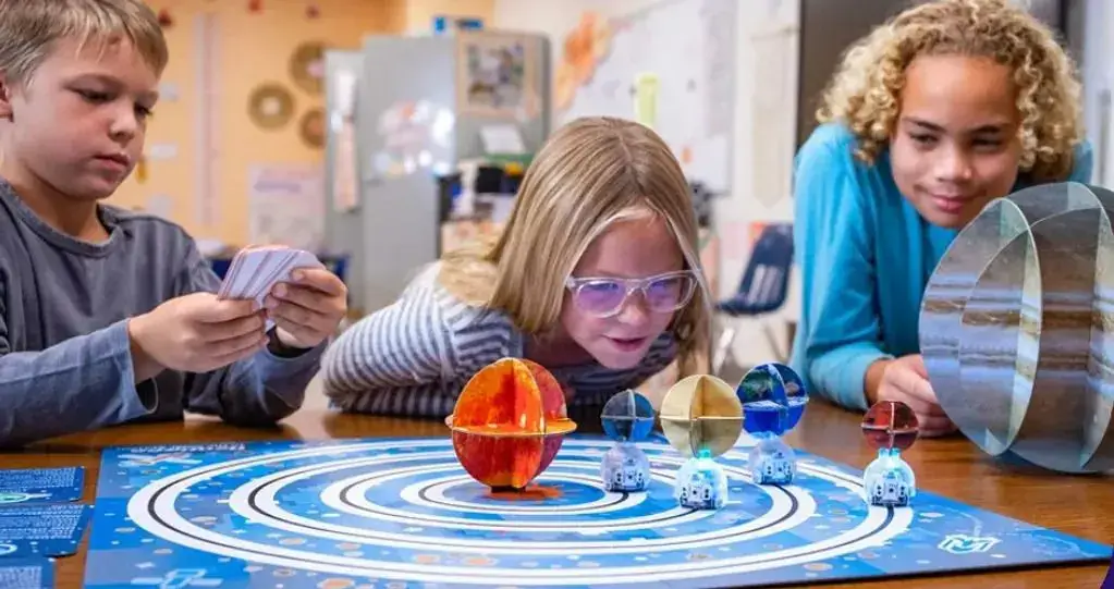 A girl is playing with some toys on the table