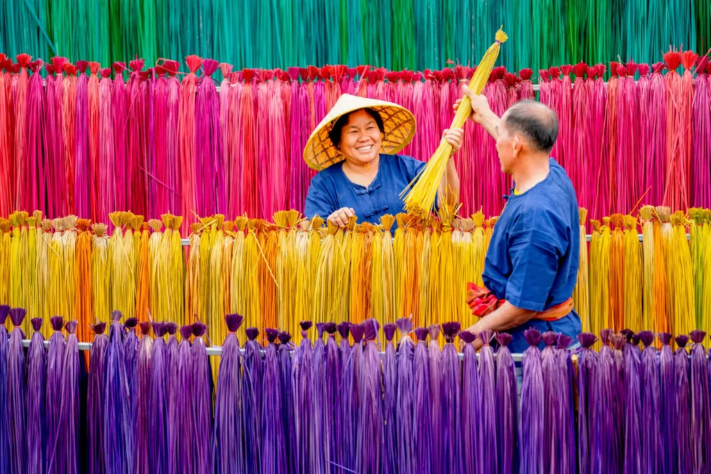 People working with colorful dyed threads.